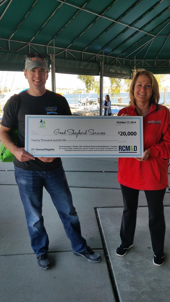 Right: Bobby Baird, GSS VP for Financial Services and Michele Wyman, interim CEO of GSS, accept a check for $20,000 from RCM&D following the regatta on October 17.