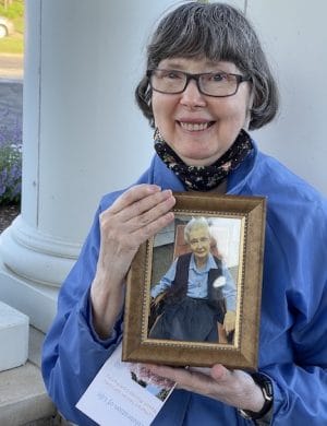 Marie Moore holds a framed portrait of her sister